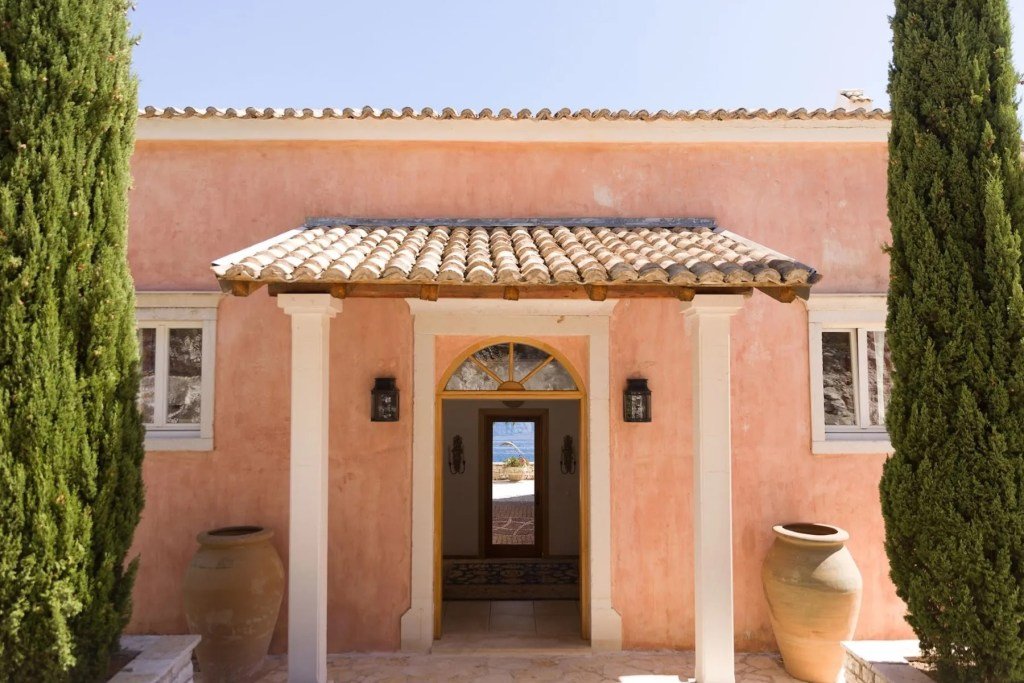 terracotta doorway that leads to waterfront vantage point in Corfu, Greece